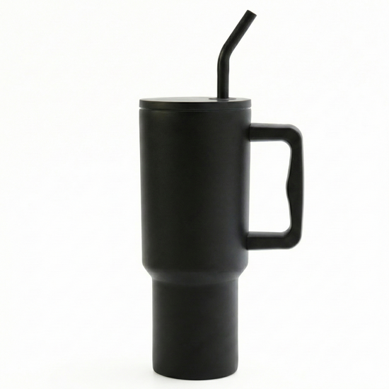 Medly 1.2L insulated travel mug in black with handle and straw. Fits car cup holders and keeps iced coffee cold or tea hot for extended periods.